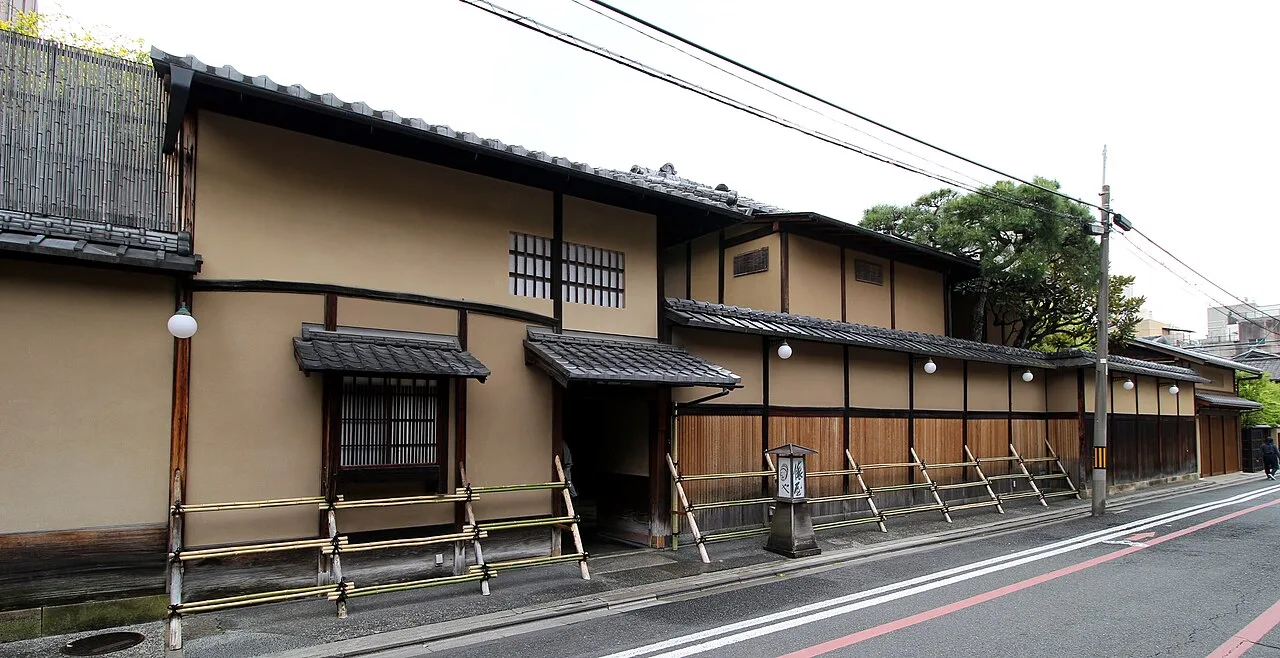 The long timber wall and tiled eaves from the street.