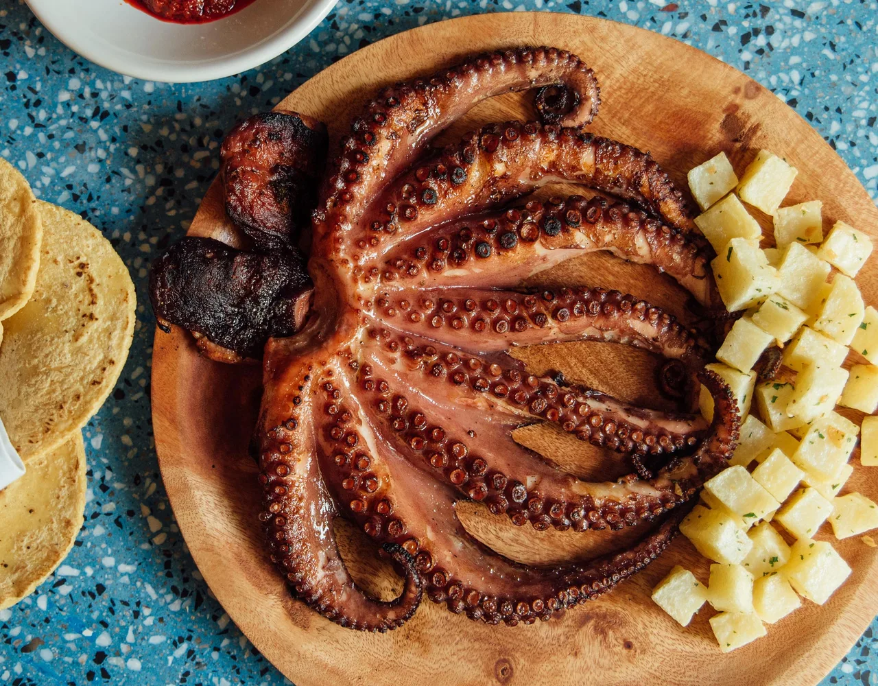 Grilled octopus served with diced potato.