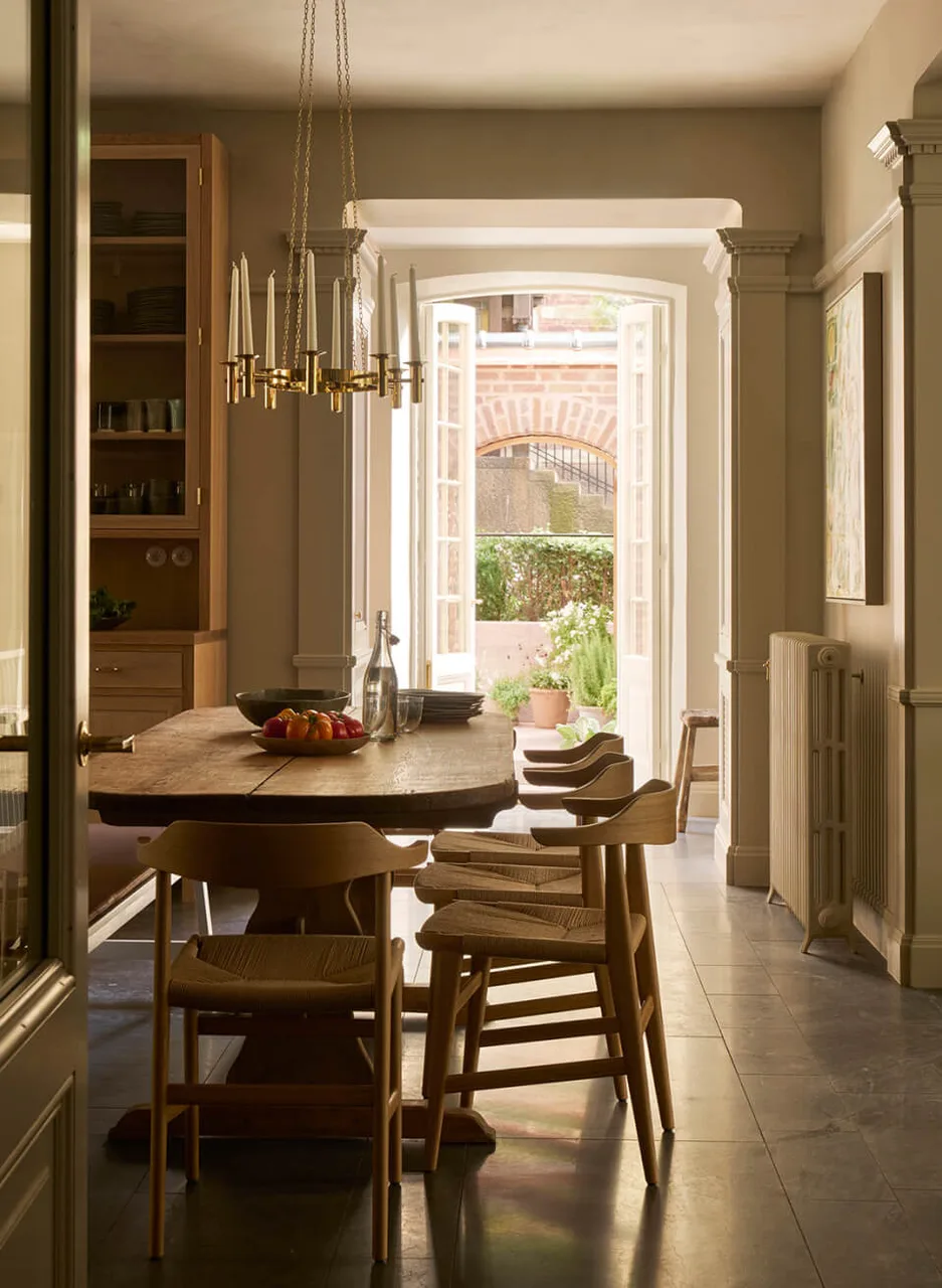 The kitchen table beside an open door to the garden.