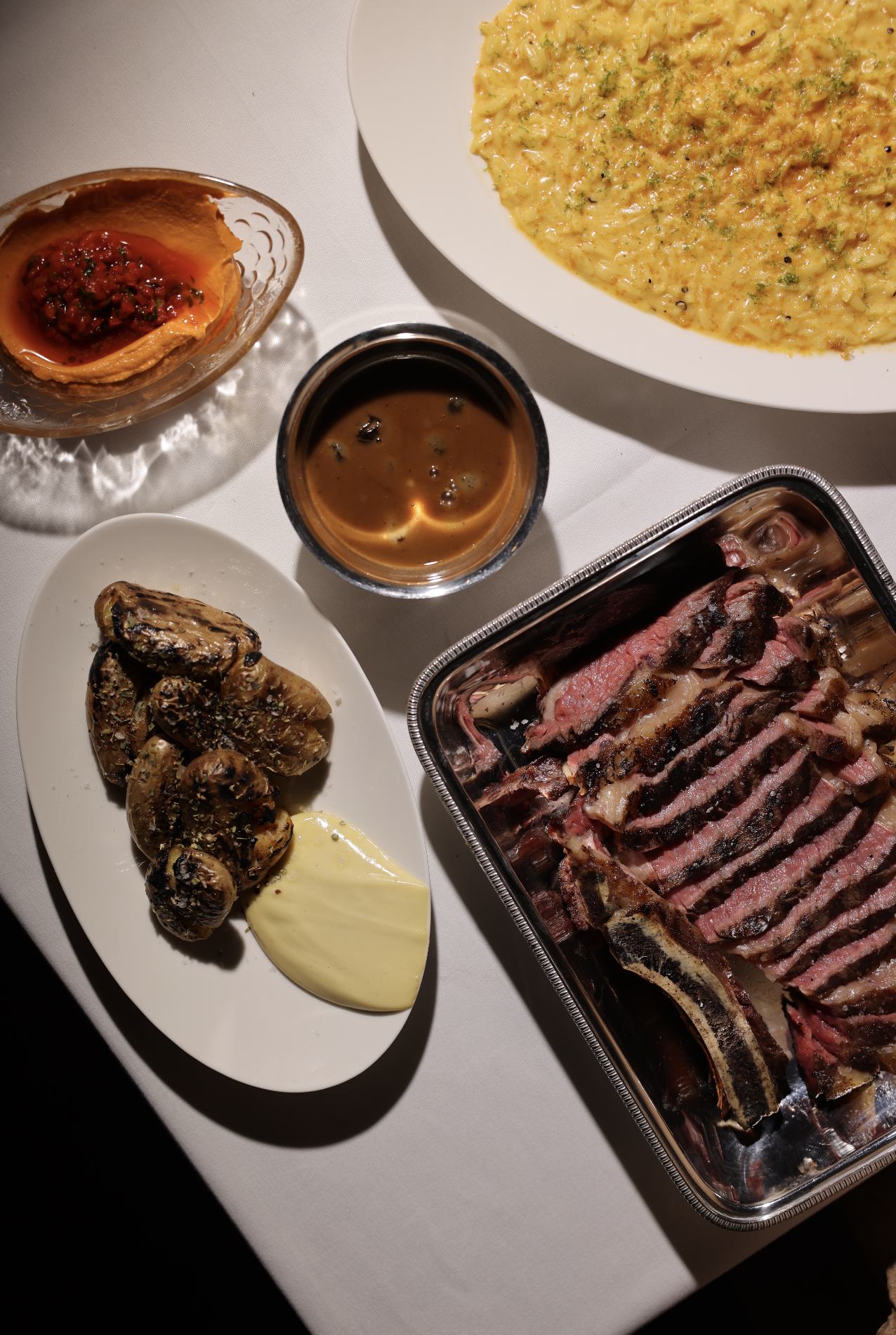Golden bottarga orzo and charcoal-grilled ribeye on the bone