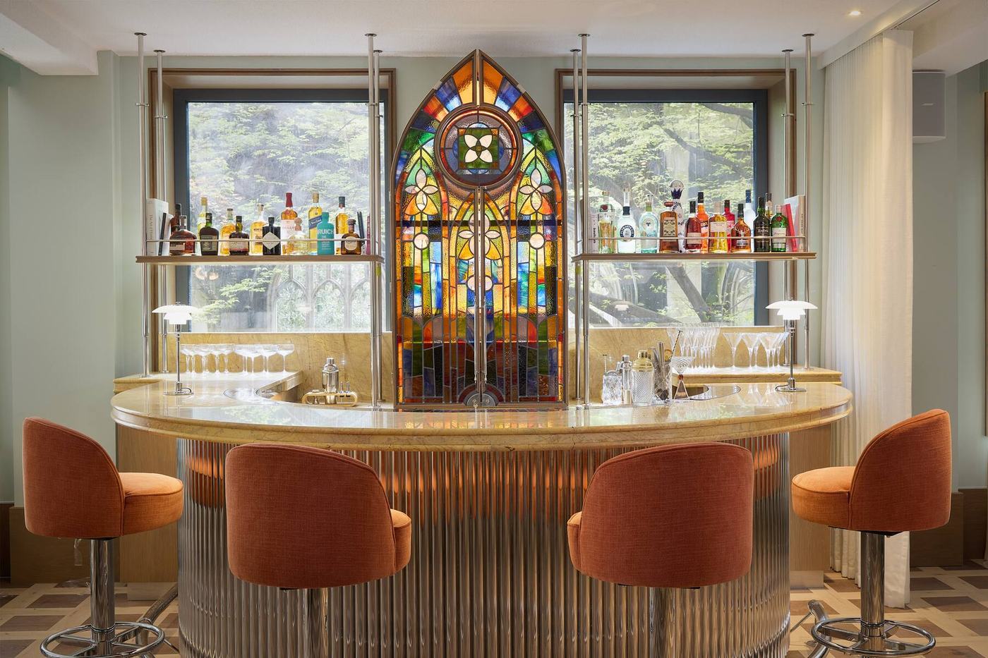 Pointed stained-glass window behind the bar